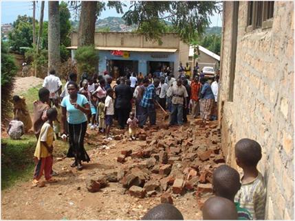 The members of World Possessor's Church International, in Namasuba, Uganda, examine the rubble left after an extremist Islamist attack during their worship service. November 2009