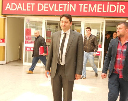 Pastor Emre Karaali of the Izmit Protestant Church outside the courthouse after the first trial hearing.The sign behind him says, 'Justice is the foundation of the state.' Izmit, Turkey; April 1, 2014 