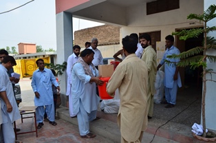 Christians receiving relief aid at St. John Bosco School. Bannu, Pakistan