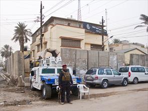 Guard protecting a church in a suburb of Baghdad. The Iraqi government ordered concrete walls to be put around churches for protection. December 2011