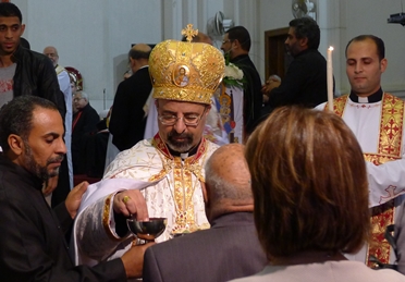 Ibrahim Isaac Sedrak, Patriarch of Egypt’s estimated 250,000 Coptic Catholics, distributing Holy Communion in March 2013 in Cairo.