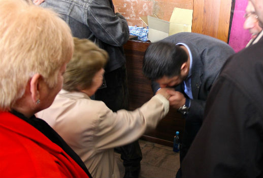 A Turkish Christian gives a traditional greeting of respect to an Armenian woman.