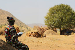 A woman reads a Bible in Sudan's Nuba Mountains.