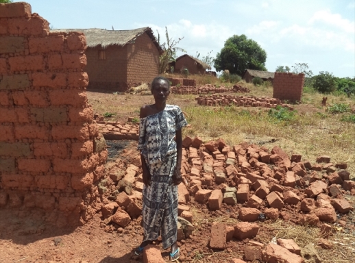 A Bozoum Christian widow stands next to her destroyed home.