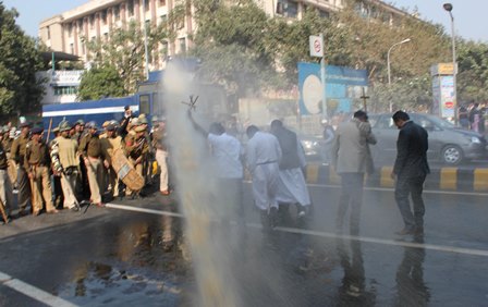 Christians, including priests, protesting India's Parliament for the rights of Dalits are blasted with dirty water canons in New Delhi; December 11, 2013.  