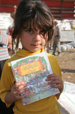 Internally displaced Iraqi girl holding a children's Bible. Kurdistan, November 2007.