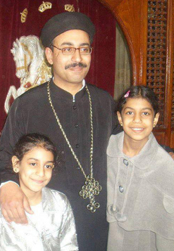 Coptic priest Mina Abboud Sharubim and his daughters in an undated photo.