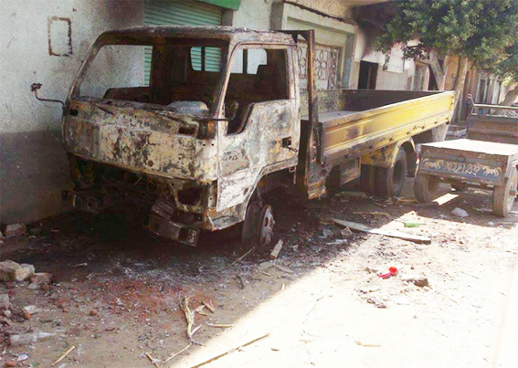 A burned truck is part of the damage caused Aug. 3 by a 4,000-person anti-Christian mob in Bani Ahmed, Egypt.