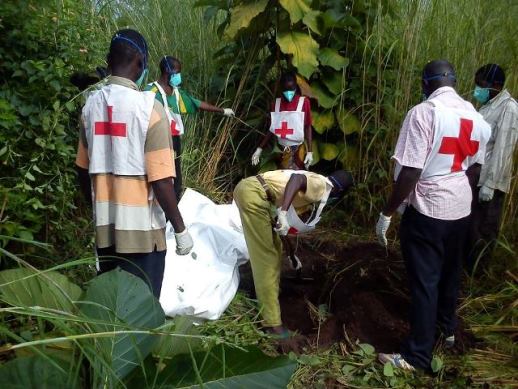 Red Cross workers bury a corpse near Bossangoa on Sept 16.