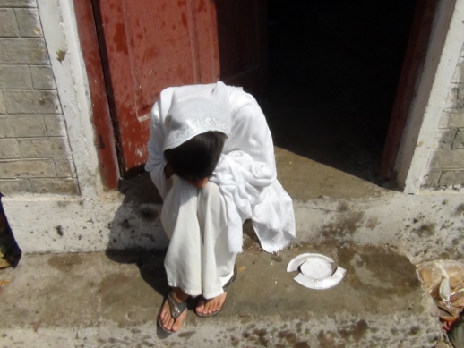 A girl sobs quietly in a the compound of All Saints Church, in Peshawar, Pakistan