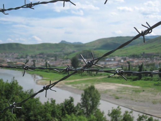 North Korea seen through barbed wire at the China border.