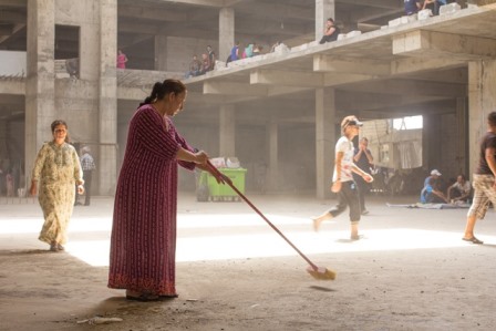 A Christian Iraqi refugee sweeping the concrete floor of the unfinished building where she now lives. Ankawa; August 20 2014 