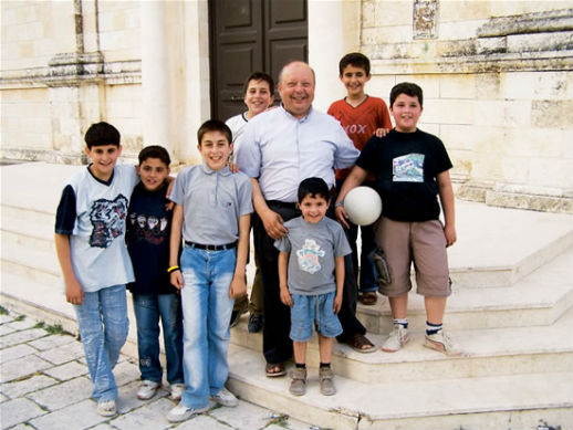 Rev. Hanna Jallouf, a Fransciscan friar, and friends at St. Joseph Convent in Knayeh, a village in northern Syria, in a 2008 photo.