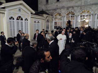 Greek Orthodox Patriarch Bartholomew escorts Pope Francis after evening mass at the patriarchate in Istanbul 
