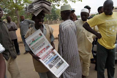 Newspaper vendor outside a polling station during the 2011 elections in Nigeria. 