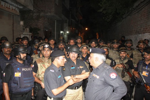 Police officers meeting after quelling protestors during unrest 2 weeks ago in Lahore