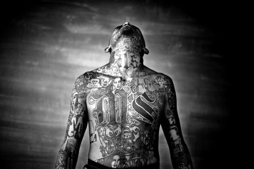 A member of the Mara Salvatrucha gang displays his tattoos inside Chelatenango prison in El Salvador.