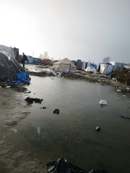 The migrants live in squalid conditions, with mud everywhere.