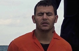 An Egyptian Christian moments before his beheading on a beach in Libya, 2015