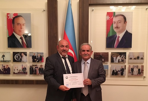 Rasim Khalilov (left), Chairman of the Bible Committee, and Pastor Elchin Pashaev, one of the founders of the new Bible Society, holding the certificate of registration.