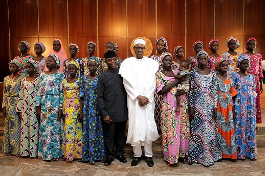 The released 21 Chibok girls met President Buhari - seen here with Vice President Osinbajo - at his villa in Nigeria's capital, Abuja, 19 Oct.