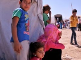 A Syrian family outside their makeshift tent in a Lebanese refugee camp, August 2016

WWM