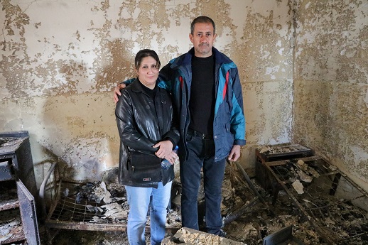 Almas and her husband, Hathem, stand inside the remains of their house, destroyed by IS, Jan 2017.