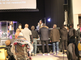 Iranian migrants line up for prayer alongside other members of the congregation at the Dk Live church in Dunkirk