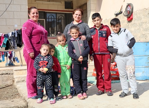 The families of Nidal (left) and Janan (centre) recently returned home to the Christian town of Telskuf.