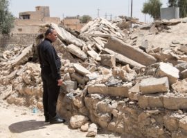 Father Thabet looks at remains of what was once the home he grew up in. (Photo: Open Doors International)