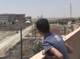 A boy recently returned to his home in the Nineveh plains, looks out over the remains of Karamles (WWM May 2017)