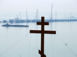 A cross seen over the construction site of a bridge across the Strait of Kerch linking Crimea to mainland Russia. (Photo by Vladimir Smirnov via Getty Images)