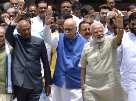Ram Nath Kovind (L), the National Democratic Alliance (NDA) governments's candidate for the upcoming presidential election, gestures as he leaves an NDA meeting with Indian Prime Minister Narendra Modi (R) and top Bharatiya Janata Party leader L.K. Advani (C) in New Delhi on June 23, 2017.