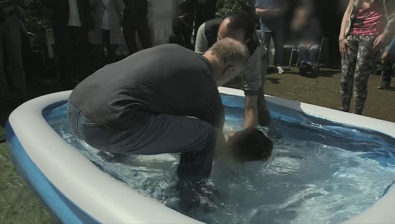An Iranian convert to Christianity is baptised in the Netherlands, in a still from the BBC documentary ‘Our World: Praying for Asylum’. One Iranian-born church told the BBC he had baptised thousands of Iranians – from the streets of Paris to Turkey.