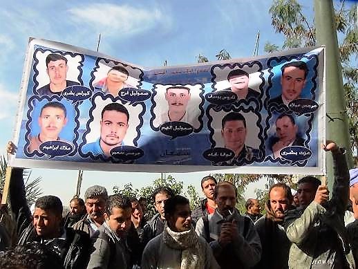 Demonstrators in Egypt hold up banner showing the faces of nine of the Copts murdered in Libya in 2015 (WWM)