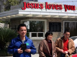 A Chinese Christian holds a Bible standing outside the largest Chinese church in the world: the Three Self church which seats 5,000 people, in Hangzhou city. (Photo: World Watch Monitor)
