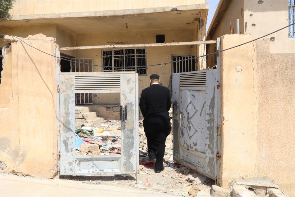 A priest enters a property in Bashiqa waiting to be repaired (WWM, August 2017)