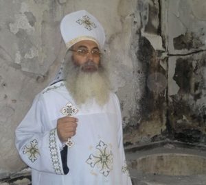 Fr. Rafael Moussa inside a fire-damaged Mar Girgis, El-Arish (World Watch Monitor)