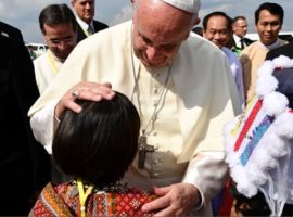 Pope Francis is greeted by a child upon arrival in Yangon, Myanmar, on 27 November. (Photo: Getty Images)