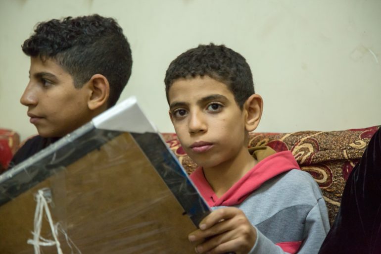 Mina (12) and his brother Marco (16) on his right hand side, still carry the wounds of witnessing the attack that killed their father in May this year. (Photo: World Watch Monitor)