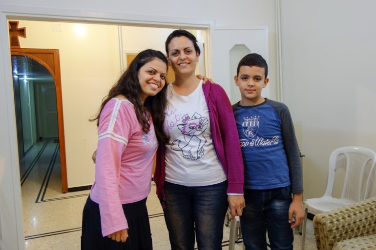 Maha (l) with two relatives "so happy" to be back home. (Photo: World Watch Monitor)