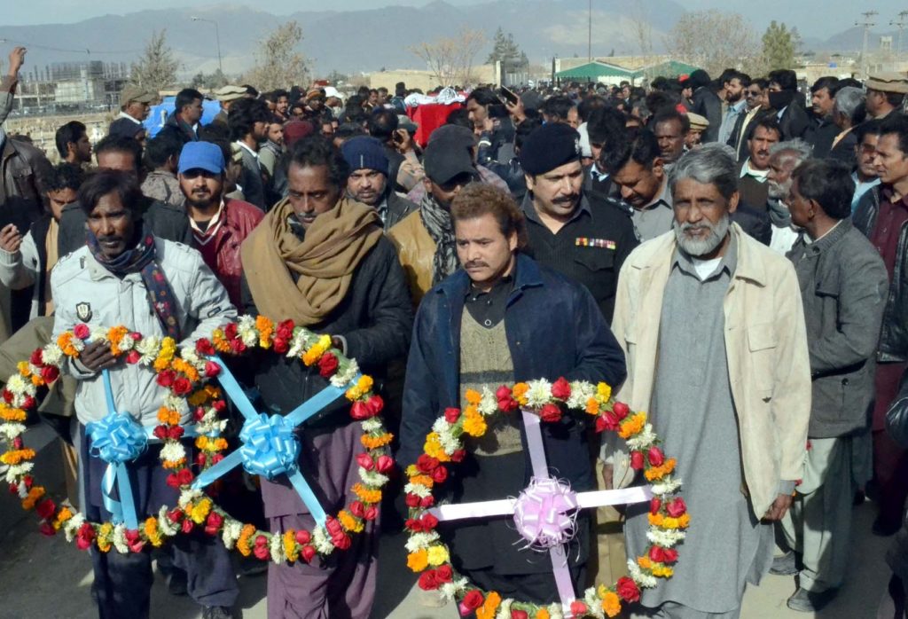 Mourners carry wreaths at the funeral of victims of the Bethel Memorial Church bombing, Quetta, Pakistan (World Watch Monitor)