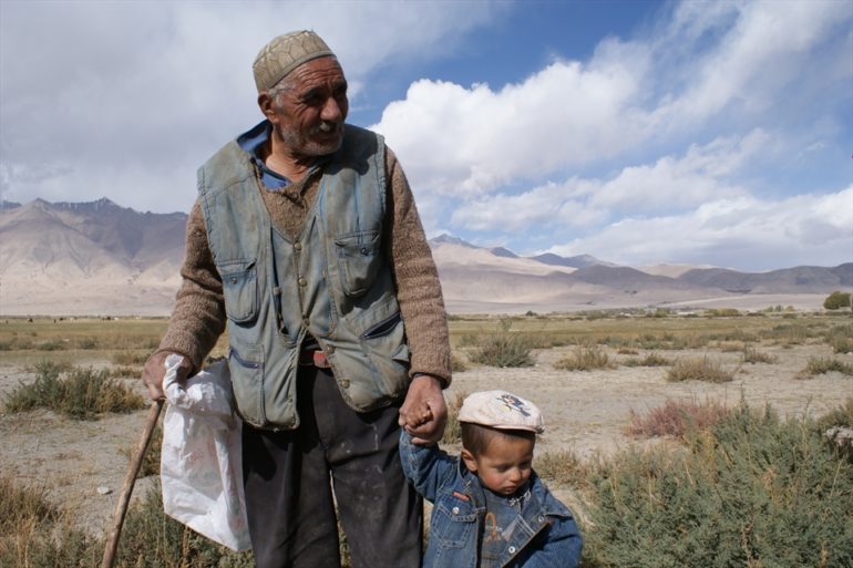 A Uyghur man and boy make their way through remote Xinjiang. (Photo: World Watch Monitor)