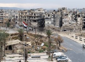 Flag of Syria is waving as sign of victory over the destroyed heavily damaged city of Aleppo. (Photo: World Watch Monitor)