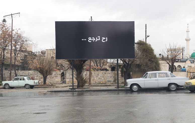 The text on the billboard translates: "Aleppo will be back" (Open Doors International)