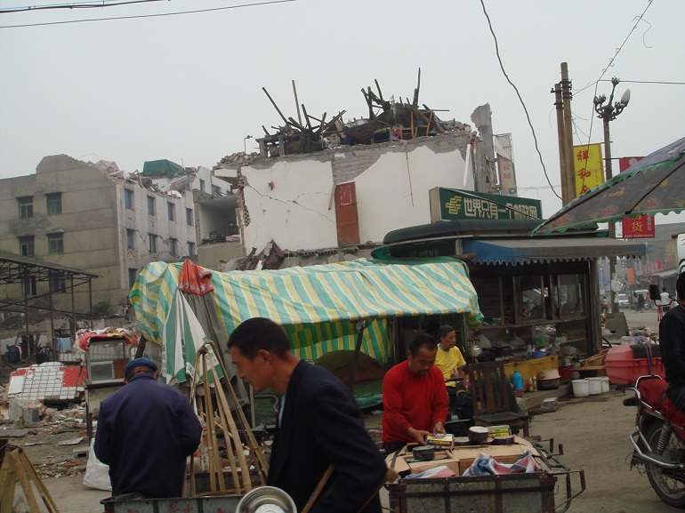 Survivors of the 2008 earthquake in Sichuan carry on with life among buildings that were destroyed. (Photo: World Watch Monitor)