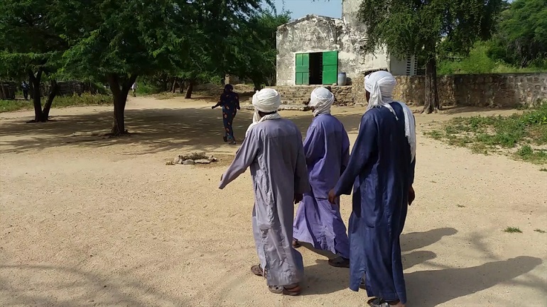 Local men walk past a village church in Chad. (Photo: World Watch Monitor)