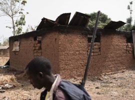 A vigilante walks through the village of Bakin Kogi, in Kaduna state, northwest Nigeria, where four people were killed in an attack by suspected Fulani herdsmen in February 2018. (Photo: Getty Images)