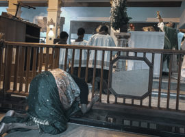 Woman kneels at altar at St Anthony's shrine, Colombo where 54 died on Easter Sunday, 2019