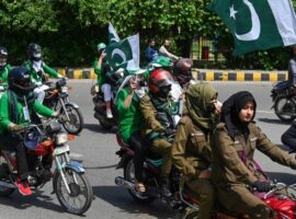People participate in a motorbike rally ahead of country’s 75th Independence Day celebrations in Lahore on August 12, 2022.
